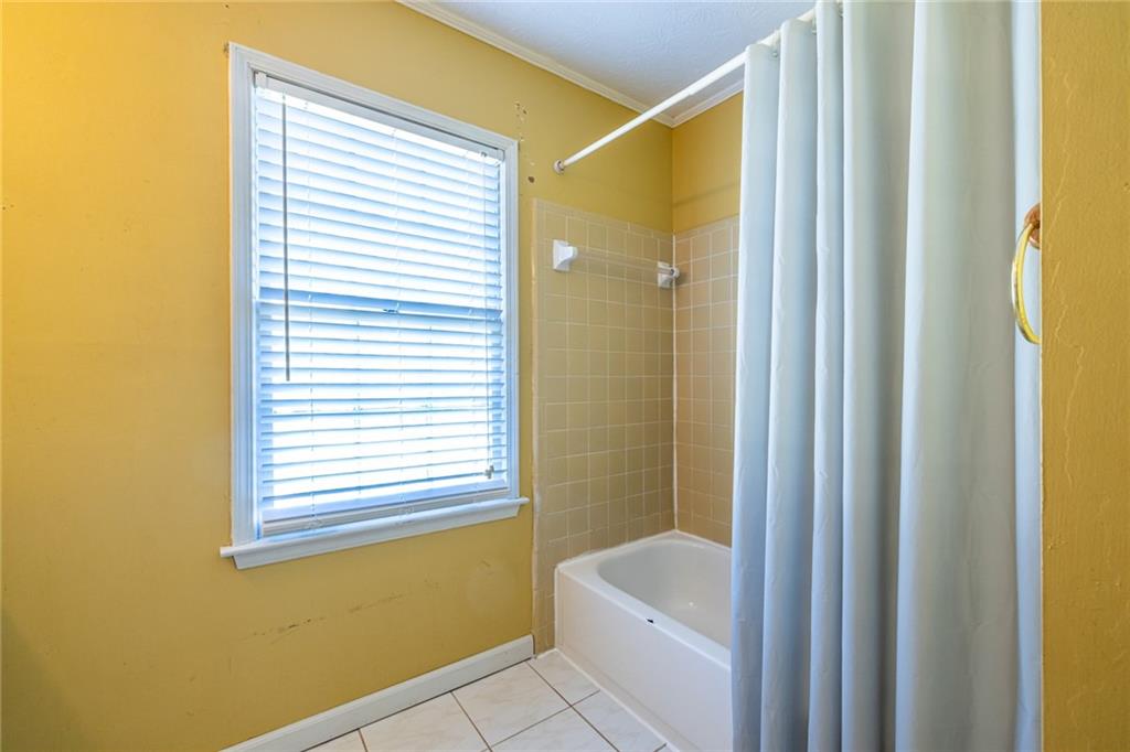 1465 Pounds Road Southwest Lilburn, GA 30047 - Photo 23 of 30 a bathroom with a sink and a mirror