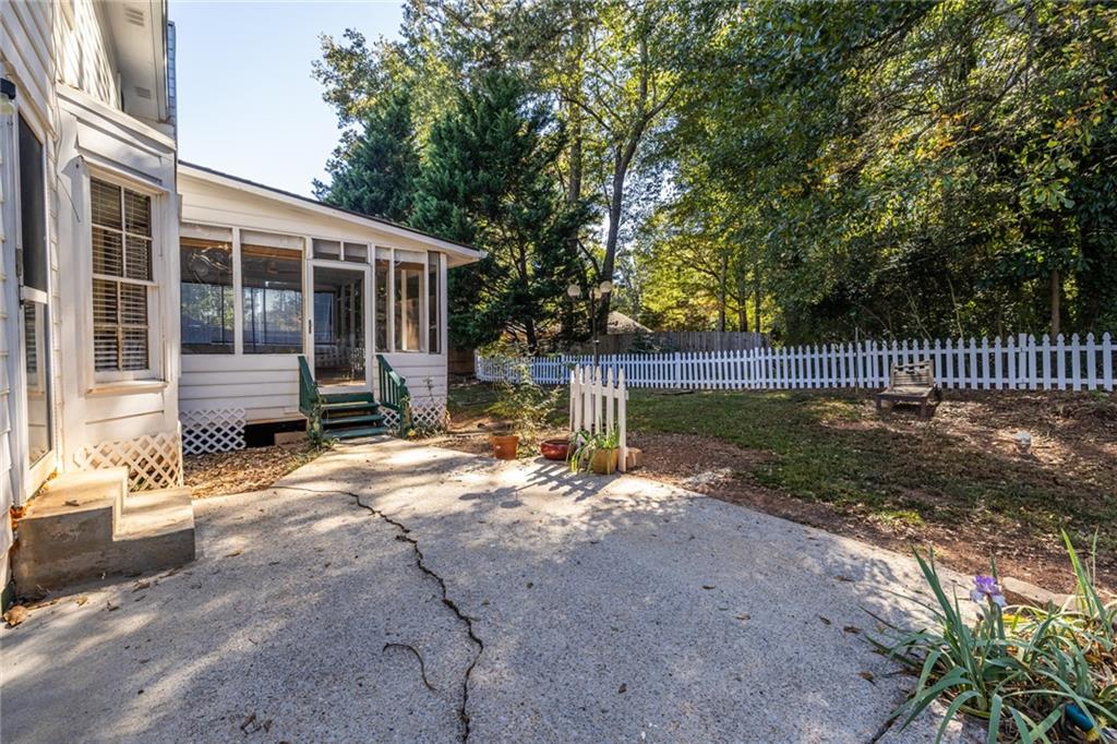 1465 Pounds Road Southwest Lilburn, GA 30047 - Photo 27 of 30 a view of a house with backyard and a tree