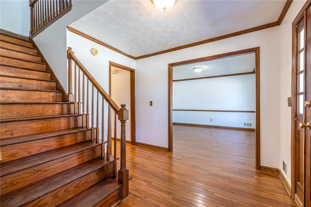 1465 Pounds Road Southwest Lilburn, GA 30047 - Photo 5 of 30 a view of an empty room with wooden floor and stairs
