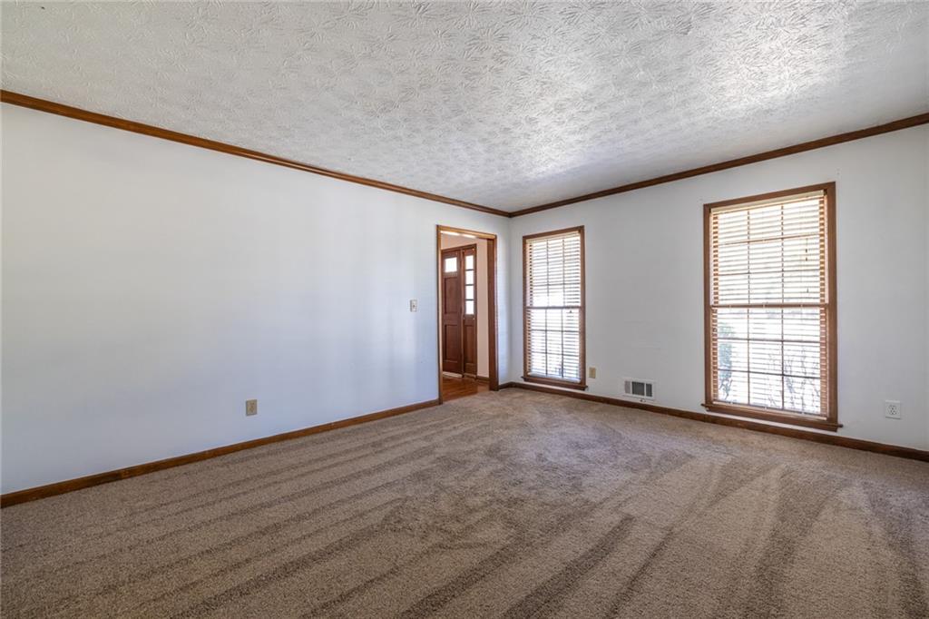 1465 Pounds Road Southwest Lilburn, GA 30047 - Photo 6 of 30 an empty room with windows