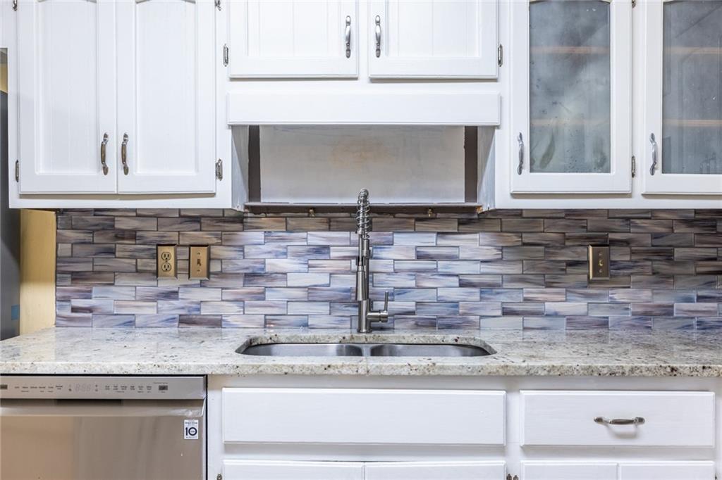 1465 Pounds Road Southwest Lilburn, GA 30047 - Photo 10 of 30 a kitchen with a sink and a mirror