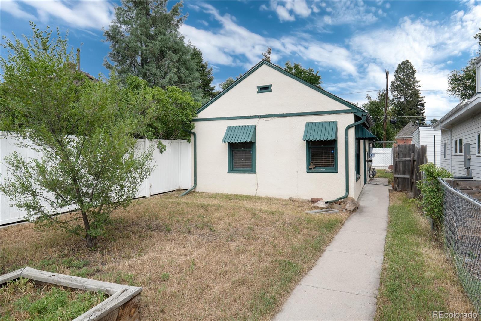 2568 Eaton Street Edgewater, CO 80214 - Photo 1 of 24 a front view of a house with a yard
