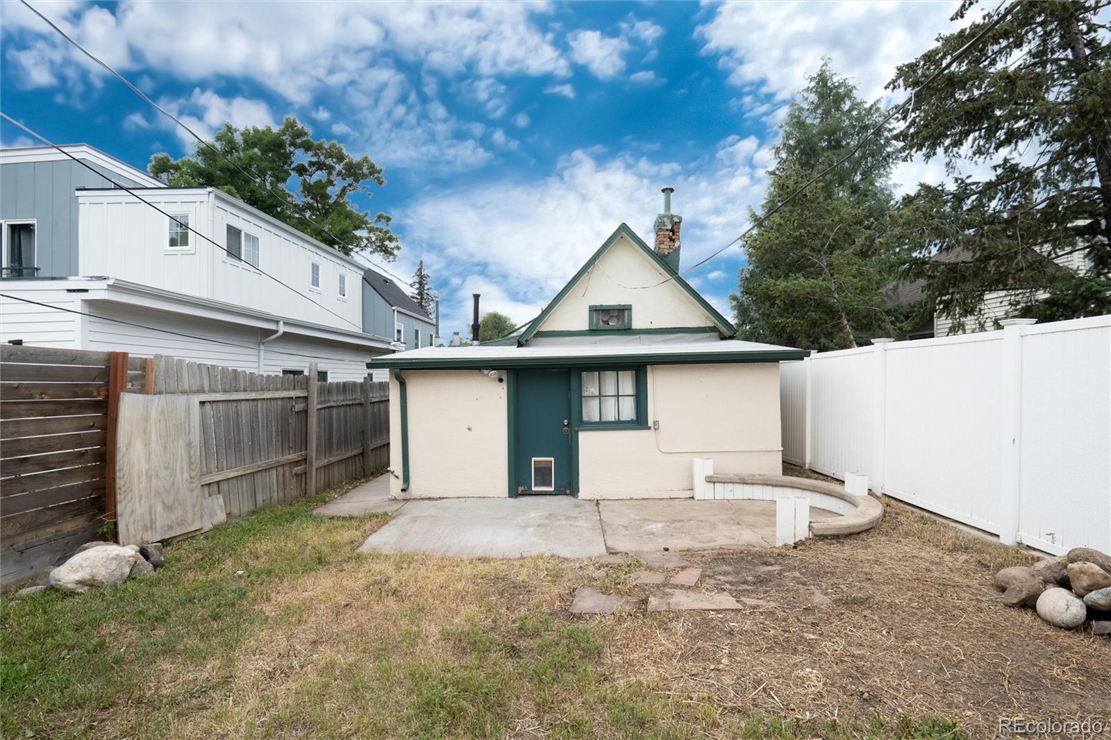 2568 Eaton Street Edgewater, CO 80214 - Photo 11 of 24 a front view of a house with a yard and garage