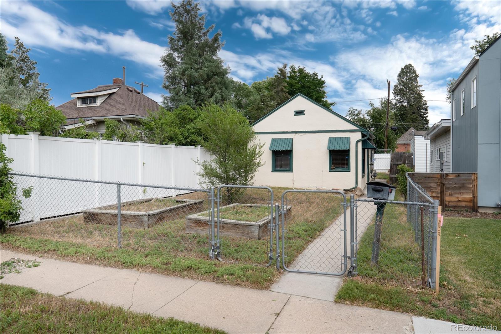 2568 Eaton Street Edgewater, CO 80214 - Photo 3 of 24 a view of a white house next to a yard
