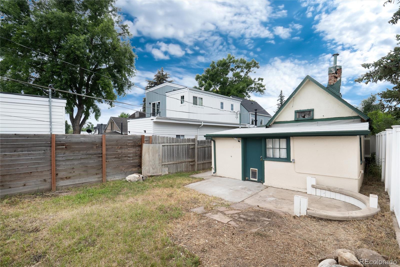 2568 Eaton Street Edgewater, CO 80214 - Photo 10 of 24 a front view of a house with a yard