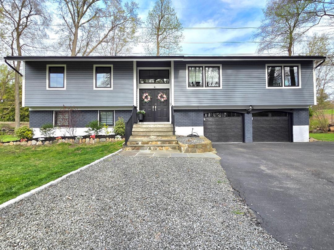 65 Sprain Road Scarsdale, NY 10583 - Photo 1 of 1 Split foyer home with brick siding, a front yard, driveway, and an attached garage