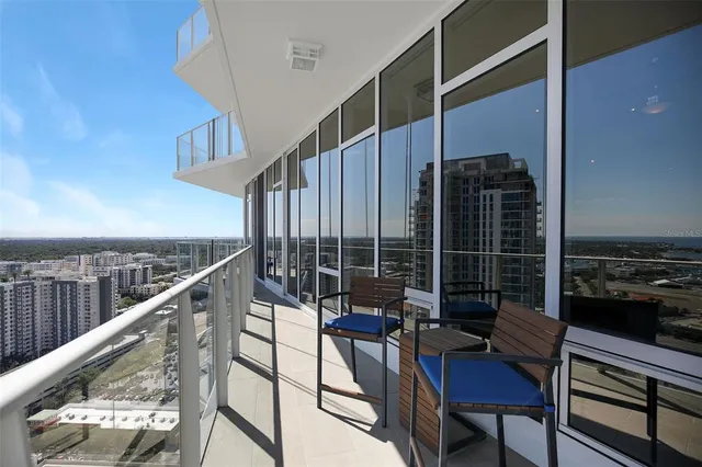 a balcony with outdoor seating and city view