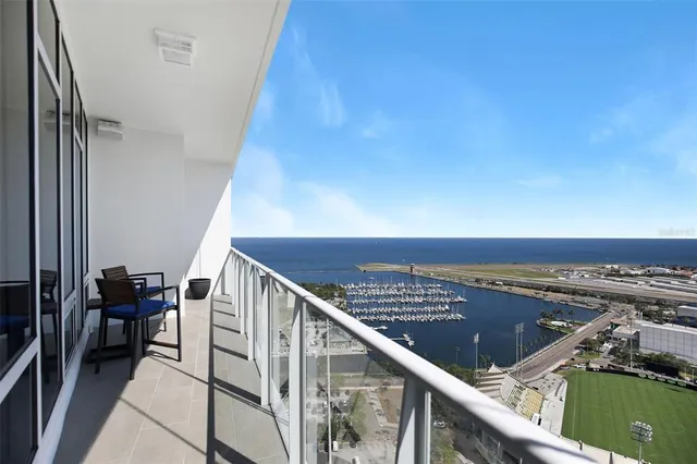 a living room with furniture a flat screen tv and a view of kitchen