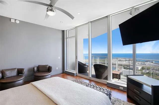 a bedroom with a large bed and a large window