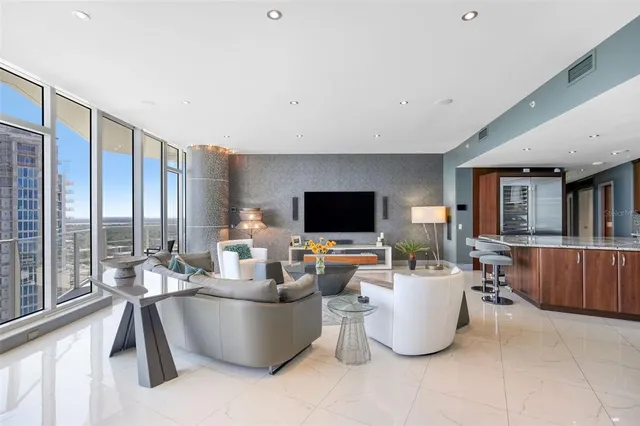 a living room with furniture and a view of kitchen