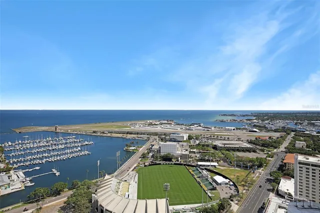 a backyard of a house with lots of green space and fountain