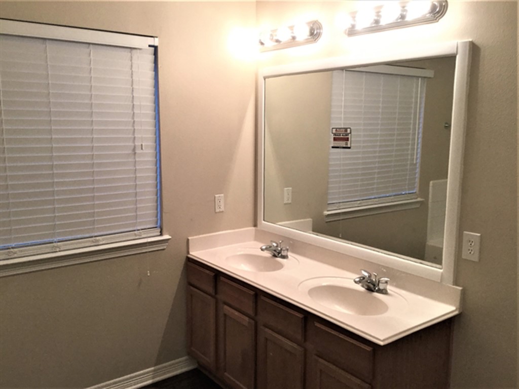 2213 Perkins Crossing Drive Conroe, TX 77304 - Photo 11 of 19 a bathroom with a sink and a mirror
