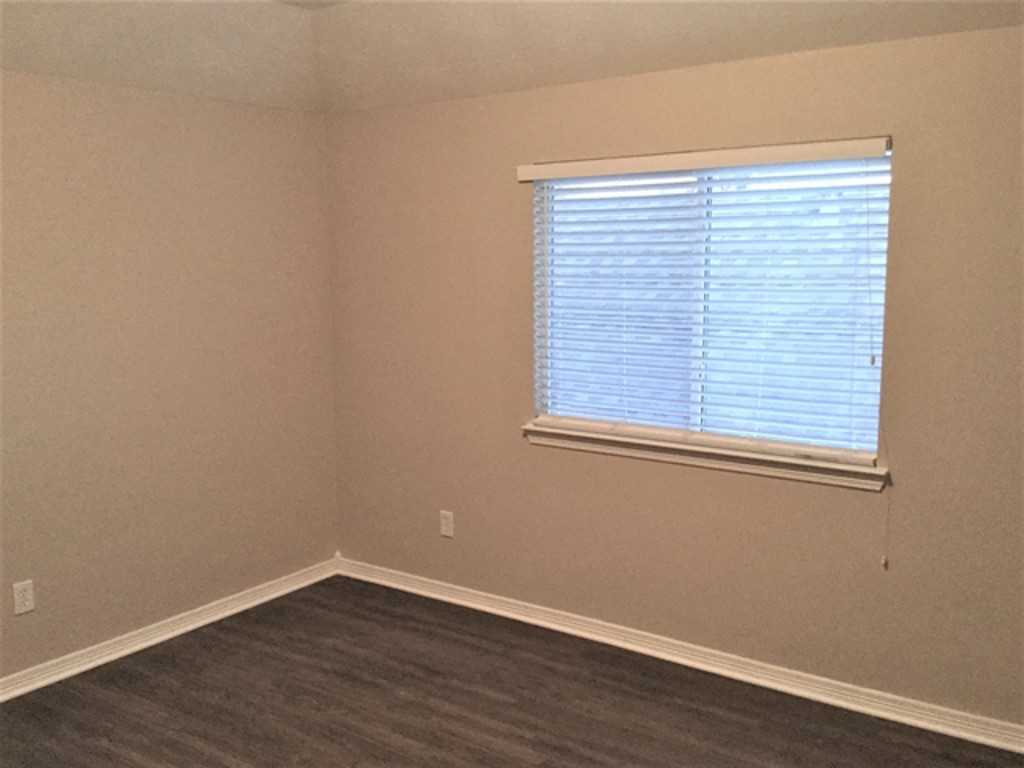 2213 Perkins Crossing Drive Conroe, TX 77304 - Photo 16 of 19 a view of a small space with wooden floor and a window