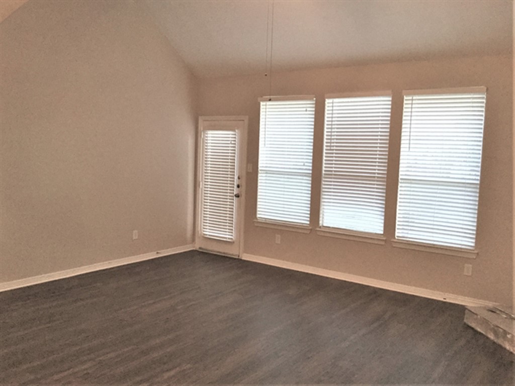 2213 Perkins Crossing Drive Conroe, TX 77304 - Photo 4 of 19 an empty room with wooden floor and windows
