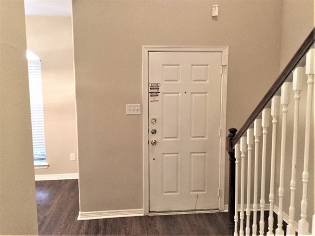 2213 Perkins Crossing Drive Conroe, TX 77304 - Photo 5 of 19 an empty room with wooden floor and windows