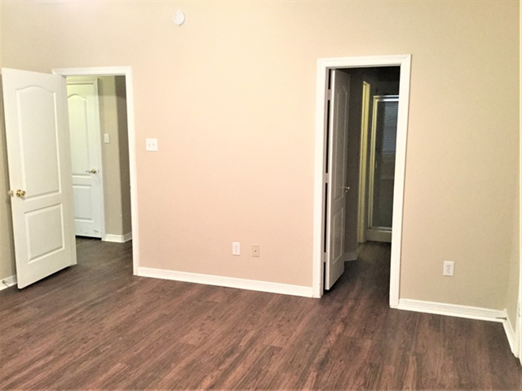 2213 Perkins Crossing Drive Conroe, TX 77304 - Photo 9 of 19 an empty room with wooden floor and closet