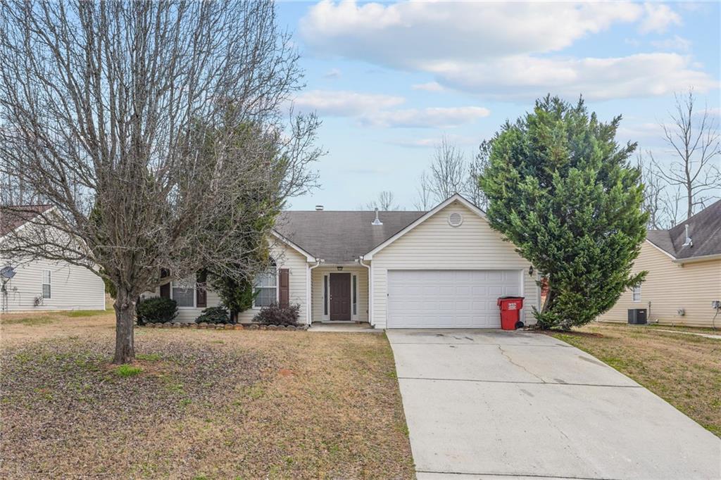 10319 Commons Crossing Jonesboro, GA 30238 - Photo 1 of 1 a front view of a house with a yard and garage