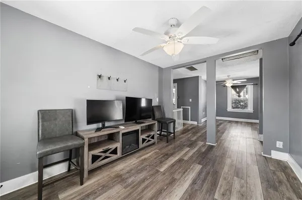 a view of a livingroom with furniture and a flat screen tv