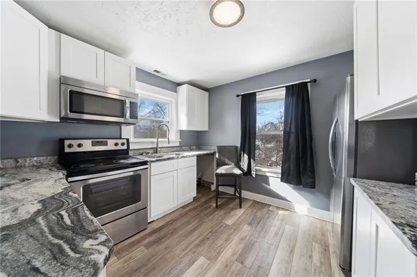 a kitchen with a stove and a microwave