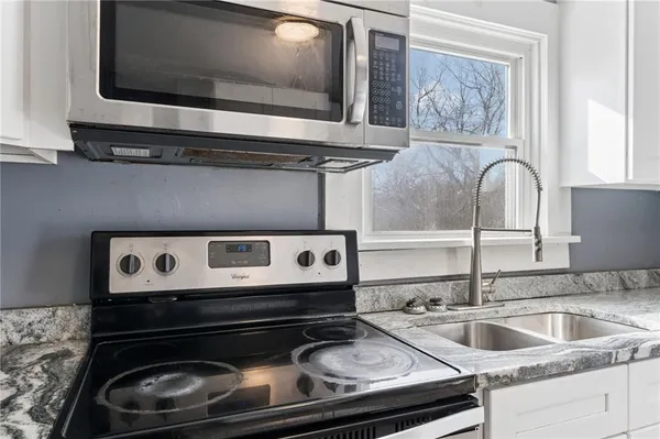 a kitchen with a refrigerator sink and stove