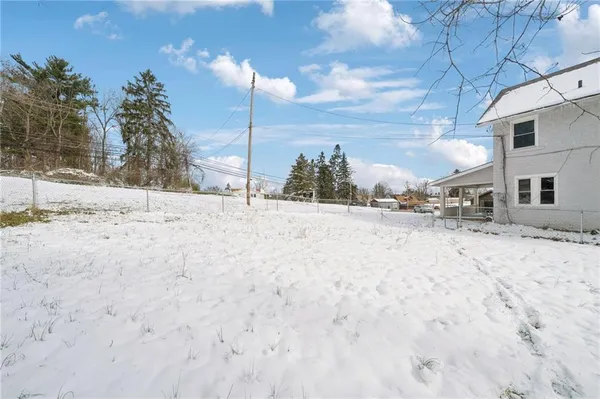 a view of white house with a snow on the road