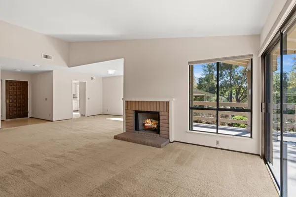 an empty room with furniture and a fireplace