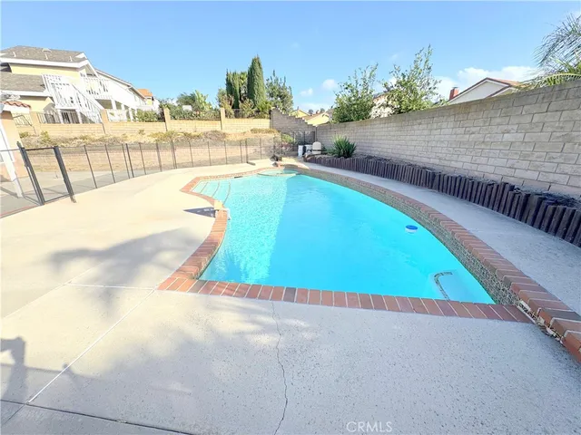 a swimming pool with outdoor seating and yard