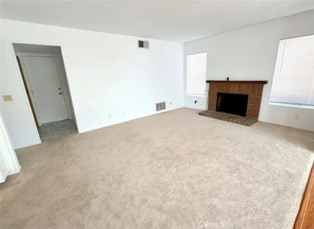 a large bedroom with a large bed and a large window