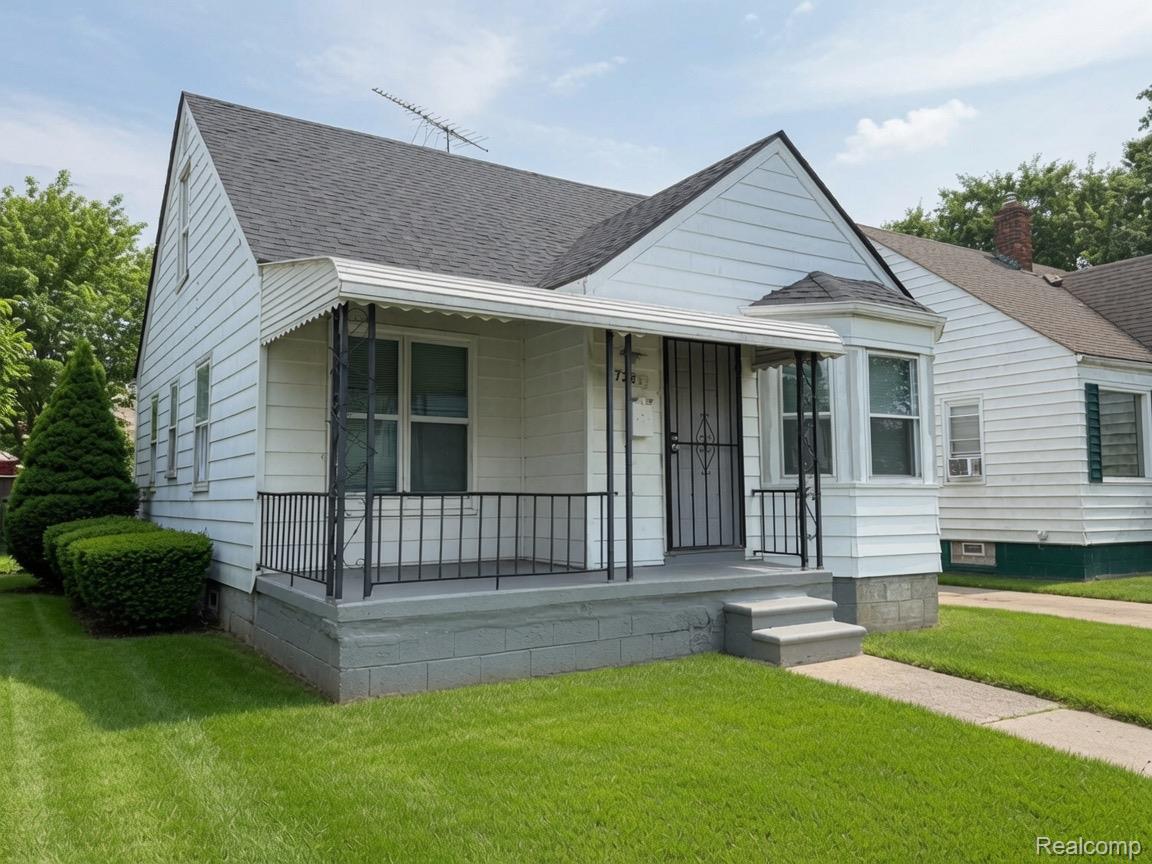 7286 Faust Avenue Detroit, MI 48228 - Photo 1 of 19 White siding exterior with a dark roof and a covered front porch featuring wrought iron railings
