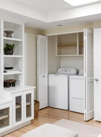a utility room with cabinets washer and dryer