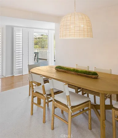 a view of a dining room with furniture and a window