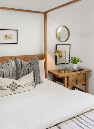a living room with a couch and a stove with wooden floor