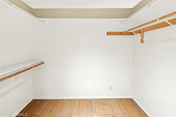 a view of walk in closet with clothes