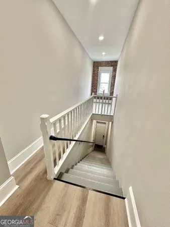 a view of entryway and hall with wooden floor