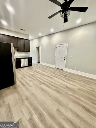 a view of an empty room with a ceiling fan