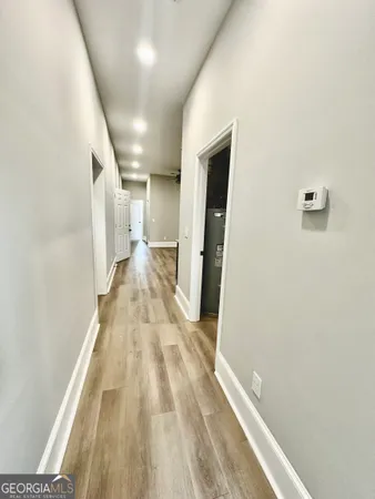 a view of a hallway with wooden floor