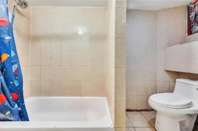 a bathroom with a toilet and bathtub