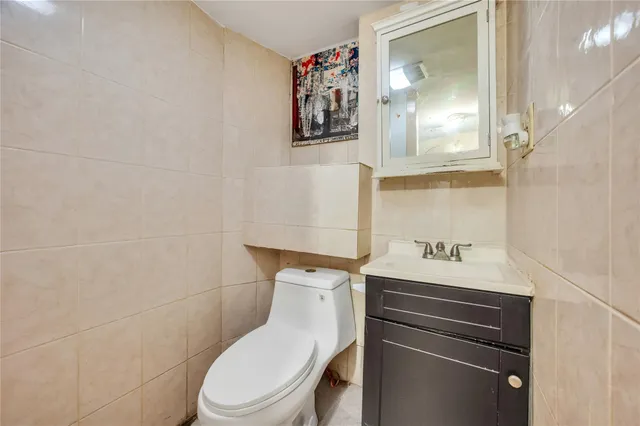a bathroom with a toilet sink and vanity