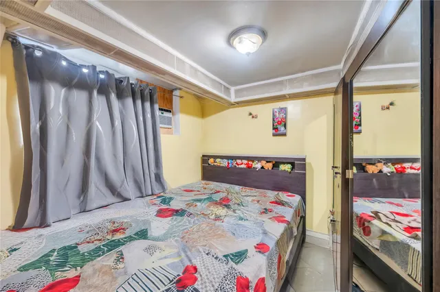 a bedroom with bed and a window