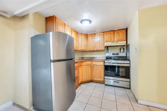 a kitchen with a refrigerator and a stove