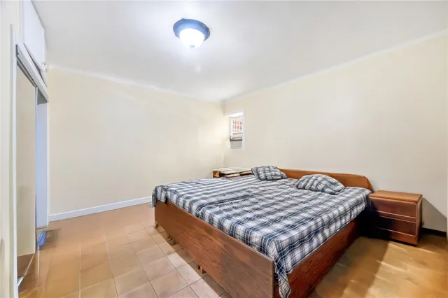 a bed sitting in a bedroom next to a window