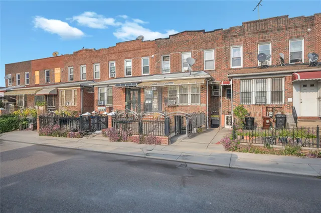 a view of a building with a yard in front of it