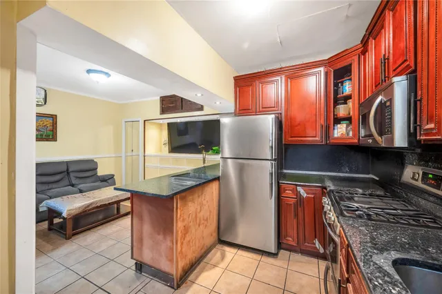 a kitchen with stainless steel appliances granite countertop a refrigerator stove and sink