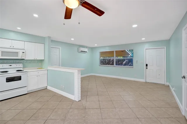 a kitchen with cabinets and wooden floor
