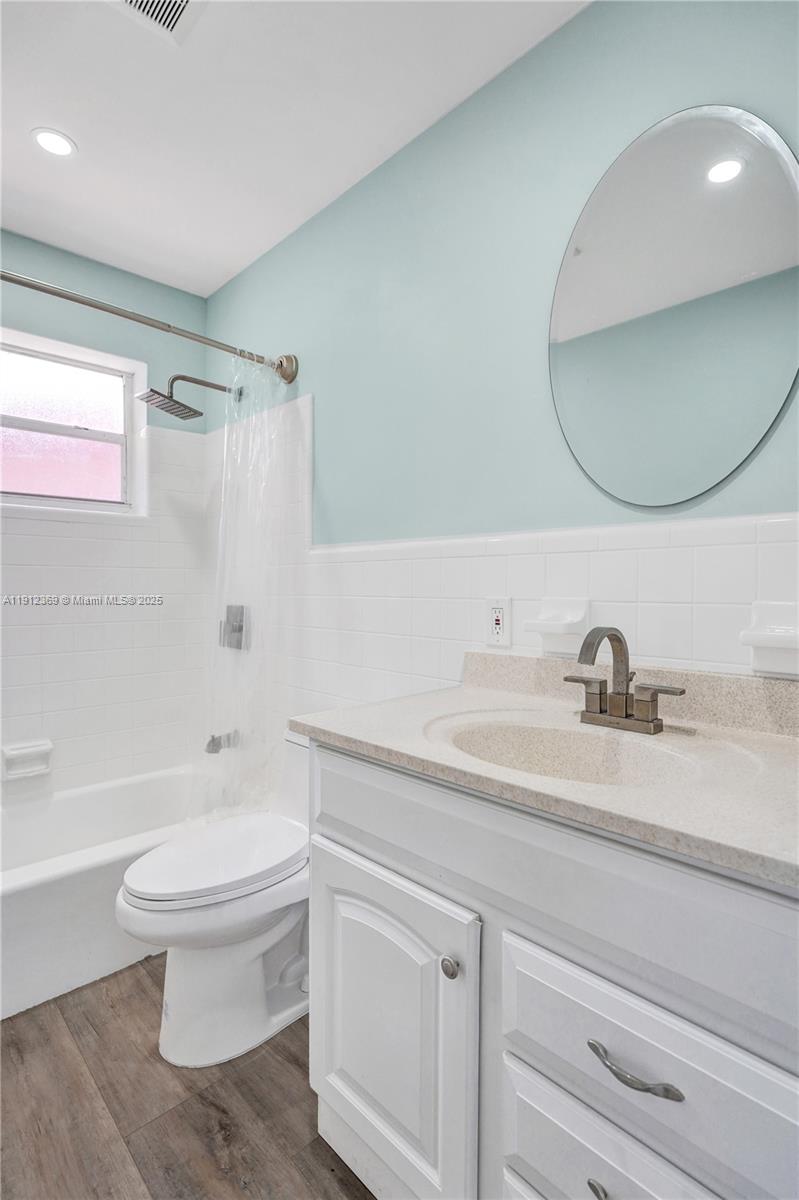 720 Southeast 15th Street, Unit 1 Fort Lauderdale, FL 33316 - Photo 22 of 38 a bathroom with a sink a toilet and a mirror