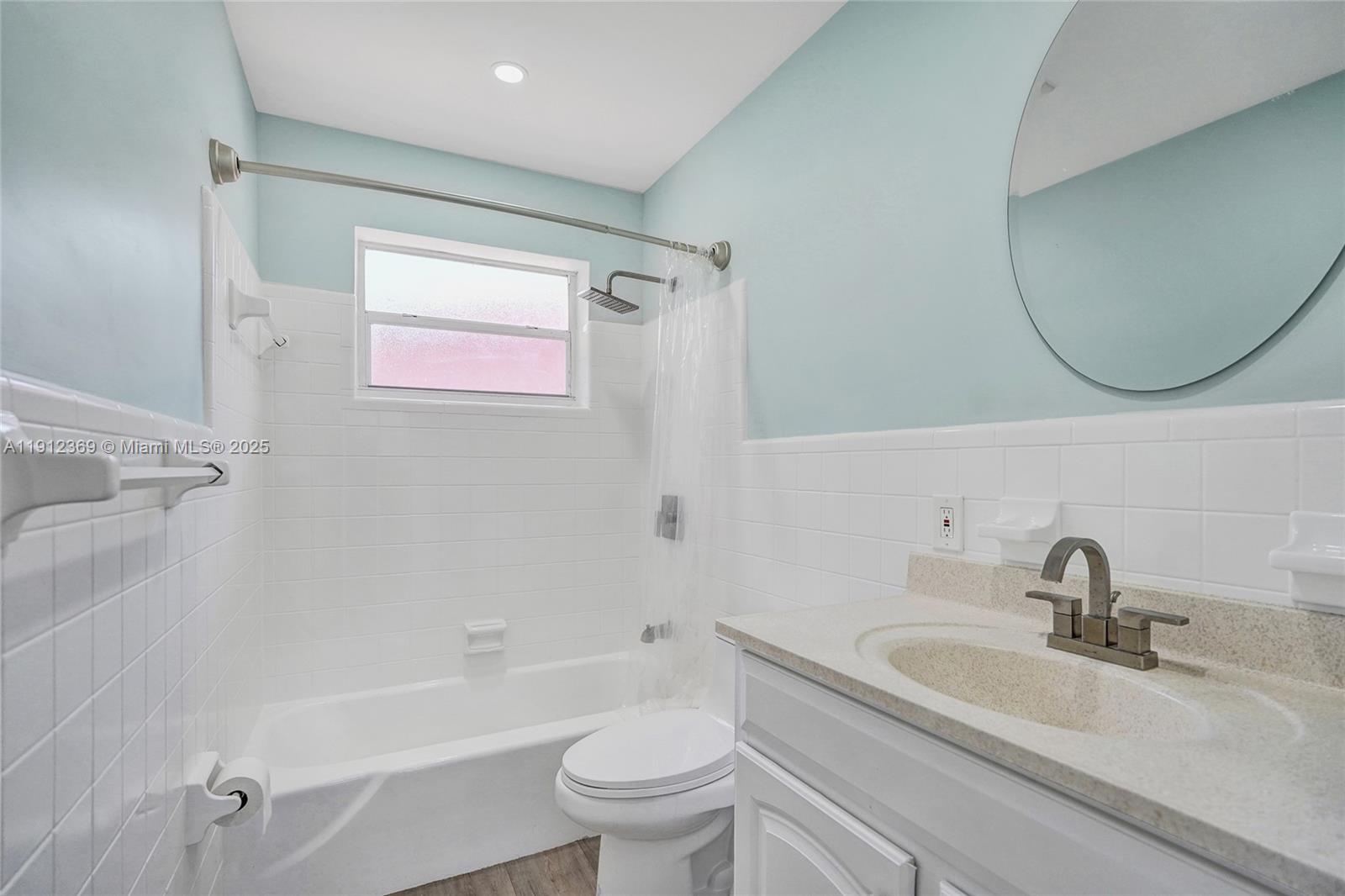 720 Southeast 15th Street, Unit 1 Fort Lauderdale, FL 33316 - Photo 23 of 38 a bathroom with a sink a toilet and a mirror