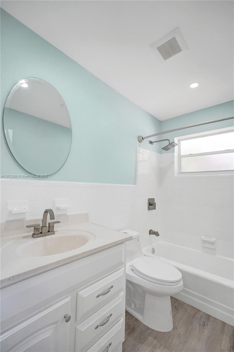 720 Southeast 15th Street, Unit 1 Fort Lauderdale, FL 33316 - Photo 24 of 38 a bathroom with a toilet a sink a mirror and bathtub
