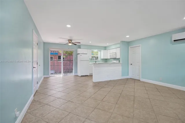 a view of a kitchen with a refrigerator a sink and dishwasher cabinets