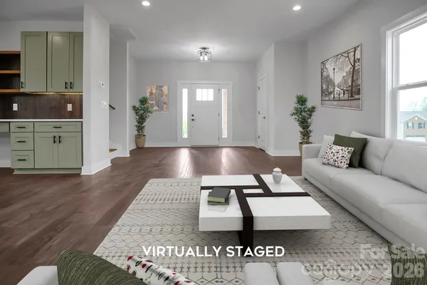 a living room with furniture and wooden floor