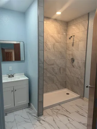 a bathroom with a shower and a sink